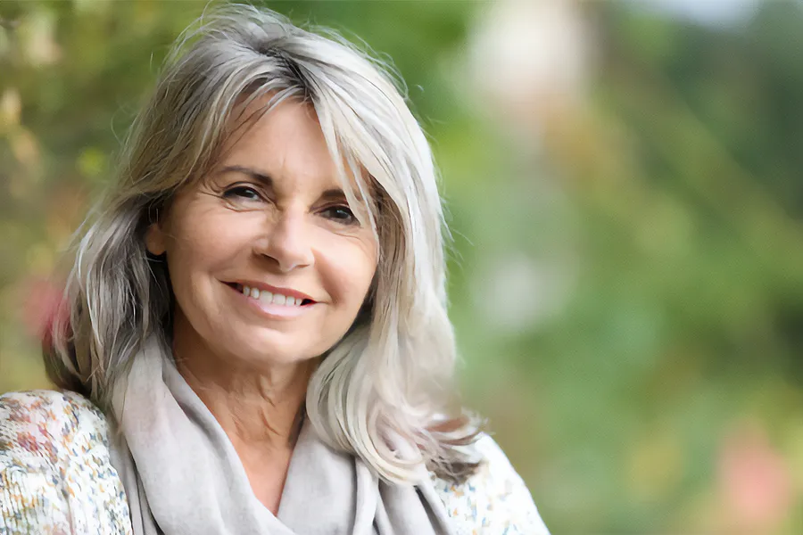 Metabolic-Syndrome-Clinic-2 A mature woman with a warm scarf smiles while enjoying the outdoors. Schedule metabolic syndrome treatment from Raving Health in Virginia Beach.